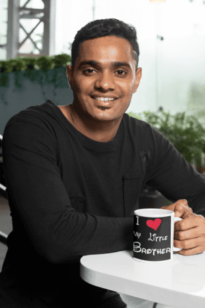 11-oz-coffee-mug-mockup-featuring-a-joyful-man-sitting-at-a-white-table-28965-2-1