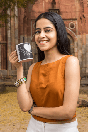 11-oz-coffee-mug-mockup-featuring-a-smiling-woman-by-an-antique-building-m25869-1