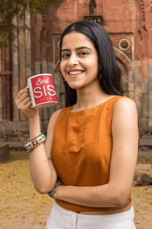 11-oz-coffee-mug-mockup-featuring-a-smiling-woman-by-an-antique-building-m25869-3-1