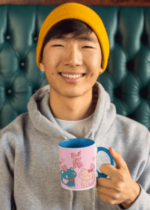 11-oz-two-toned-mug-mockup-of-a-young-man-sitting-on-a-green-leather-couch-27824-4-1