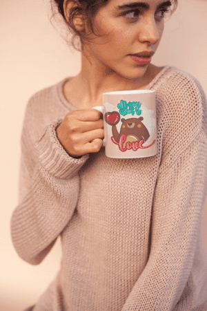 coffee-mug-mockup-held-by-a-woman-wearing-a-cozy-sweater-22441-3-1