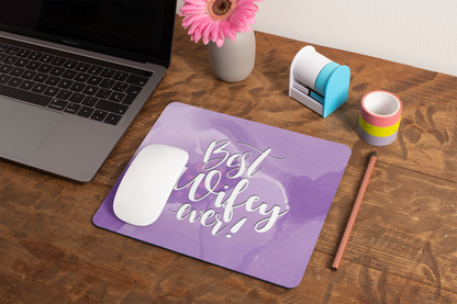 mockup-of-a-mousepad-lying-on-a-rustic-table-next-to-a-flower-vase-27554