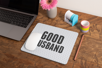 mockup-of-a-mousepad-lying-on-a-rustic-table-next-to-a-flower-vase-27554