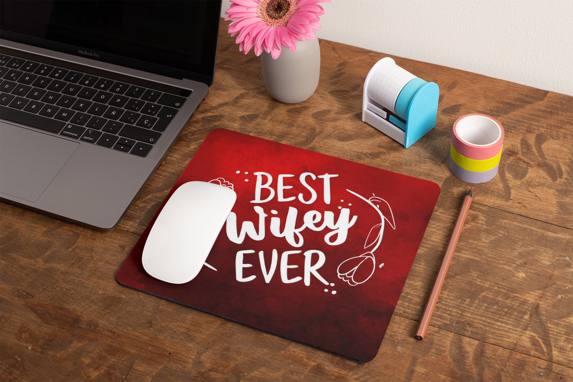 mockup-of-a-mousepad-lying-on-a-rustic-table-next-to-a-flower-vase-27554