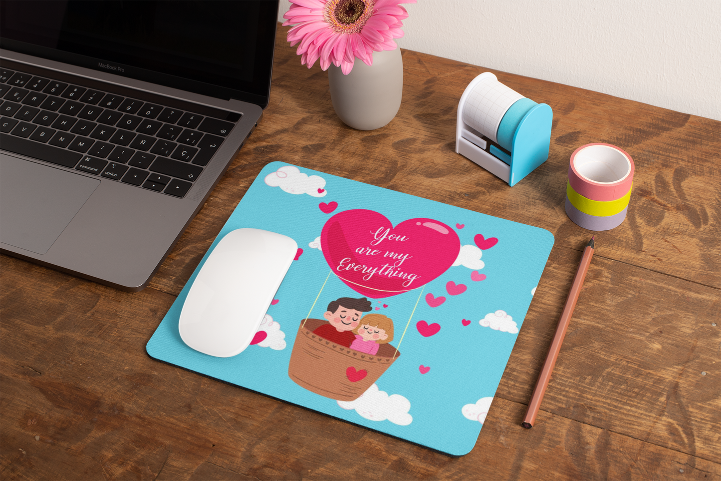 mockup-of-a-mousepad-lying-on-a-rustic-table-next-to-a-flower-vase-27554