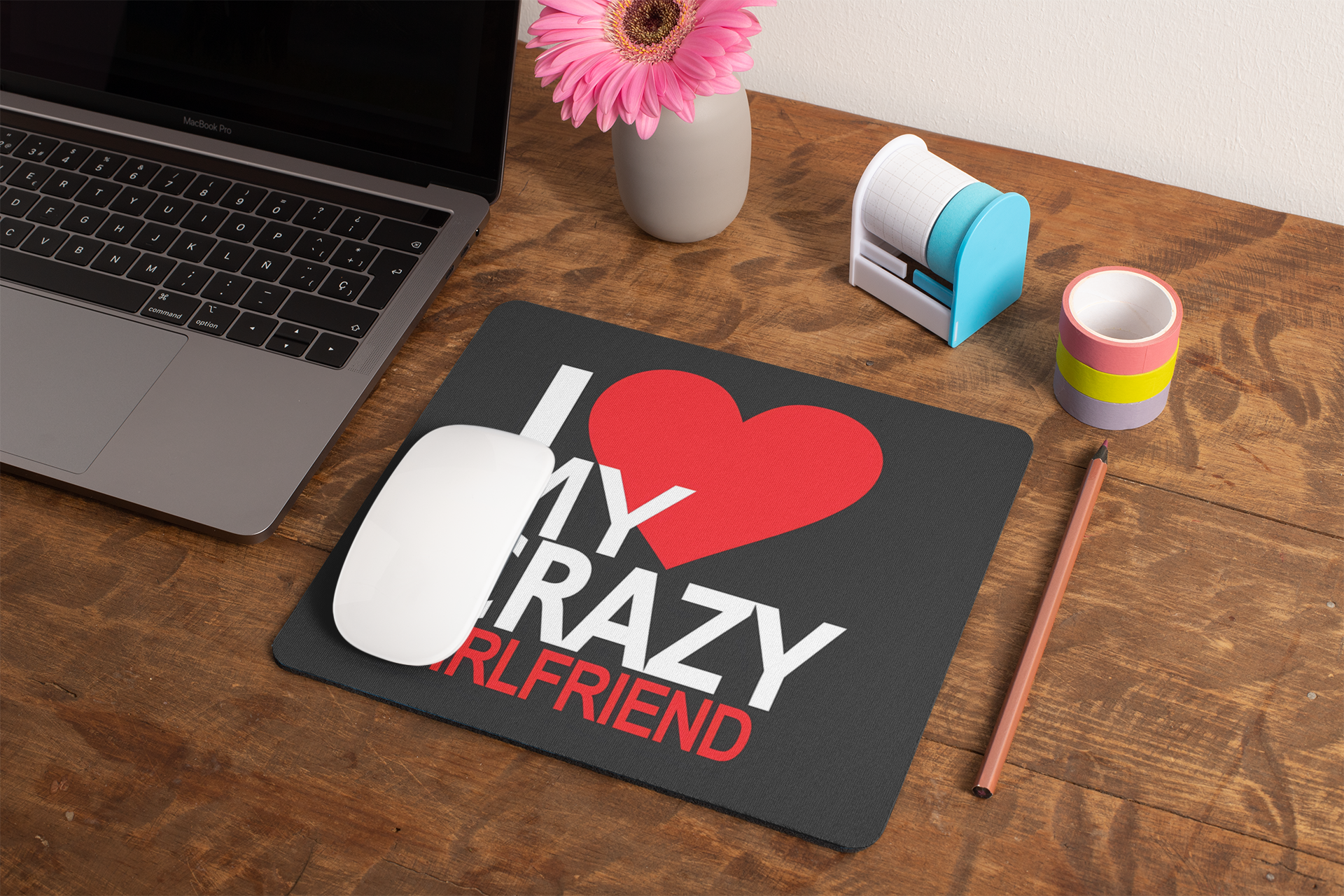 mockup-of-a-mousepad-lying-on-a-rustic-table-next-to-a-flower-vase-27554