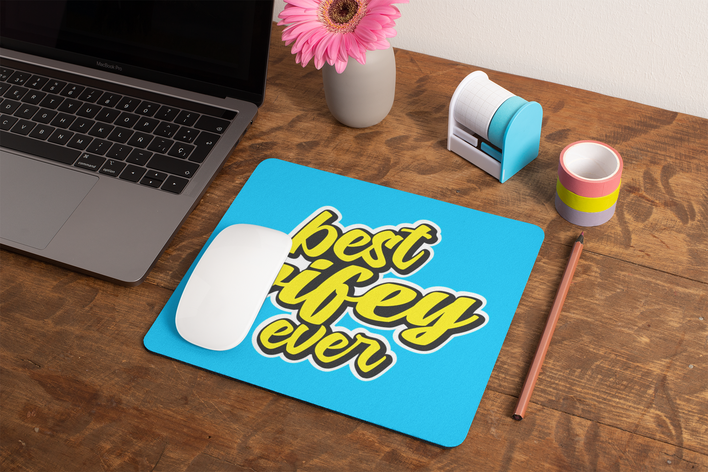 mockup-of-a-mousepad-lying-on-a-rustic-table-next-to-a-flower-vase-27554