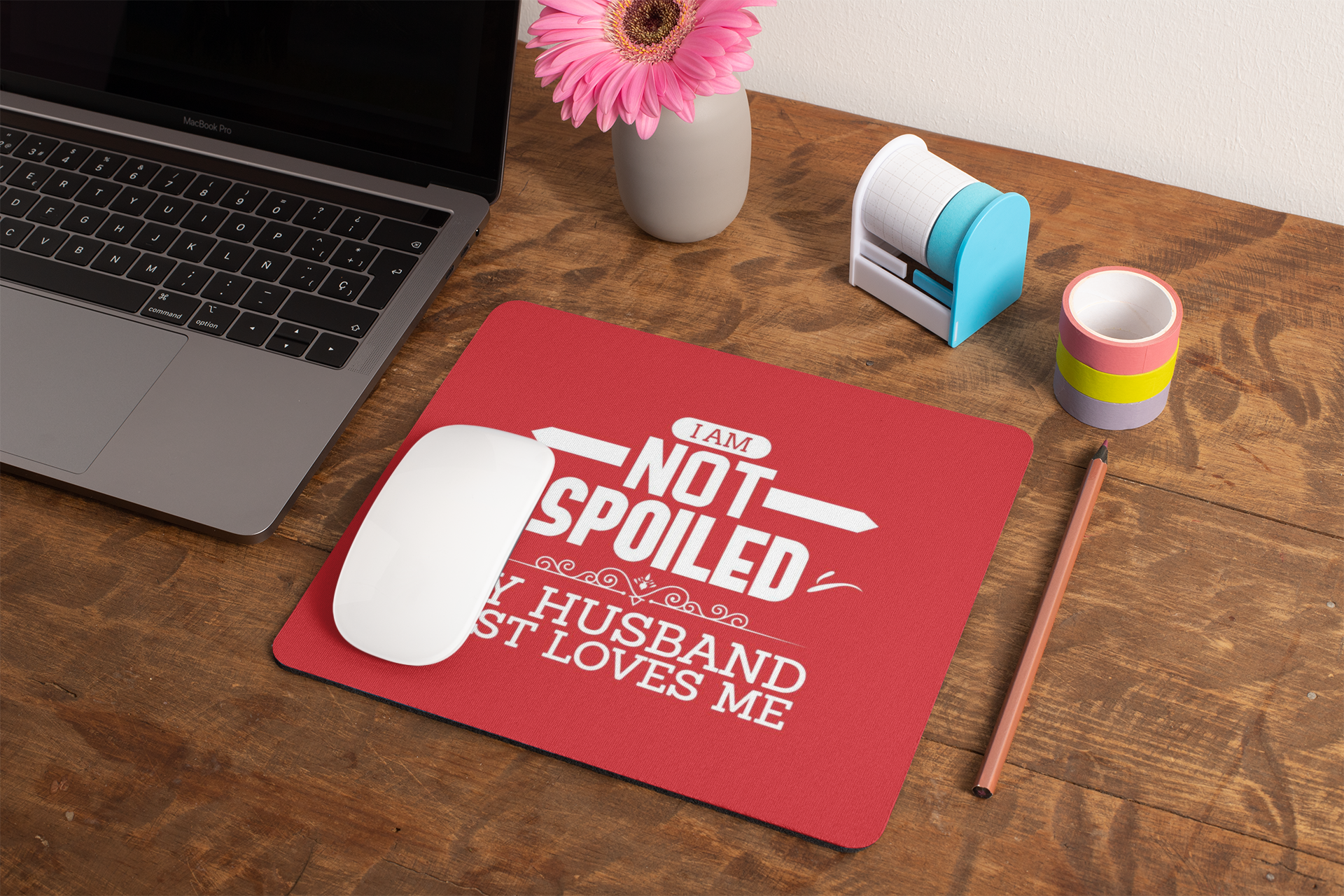 mockup-of-a-mousepad-lying-on-a-rustic-table-next-to-a-flower-vase-27554