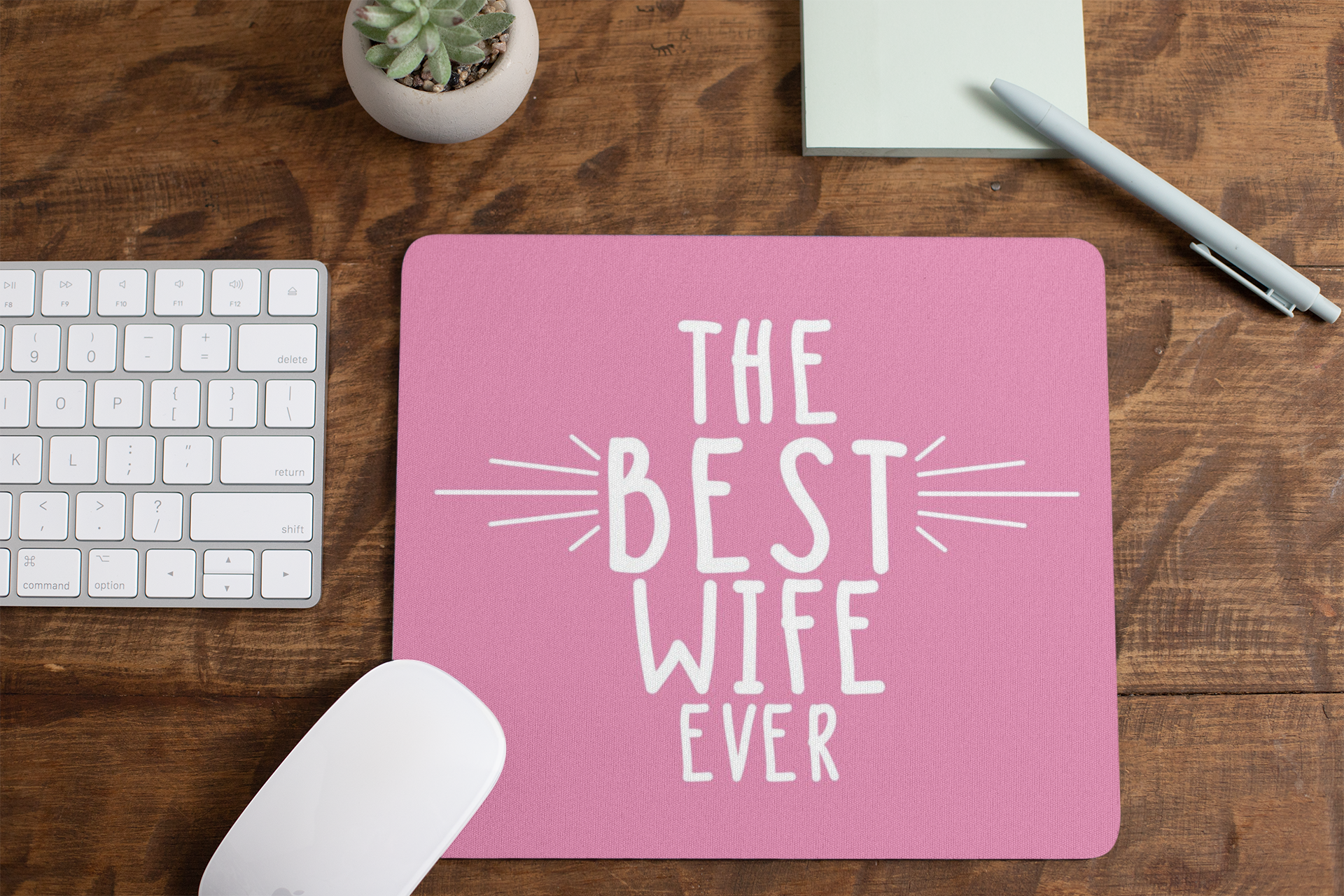 mousepad-mockup-lying-on-a-table-next-to-a-plant-pot-and-some-office-supplies-27553