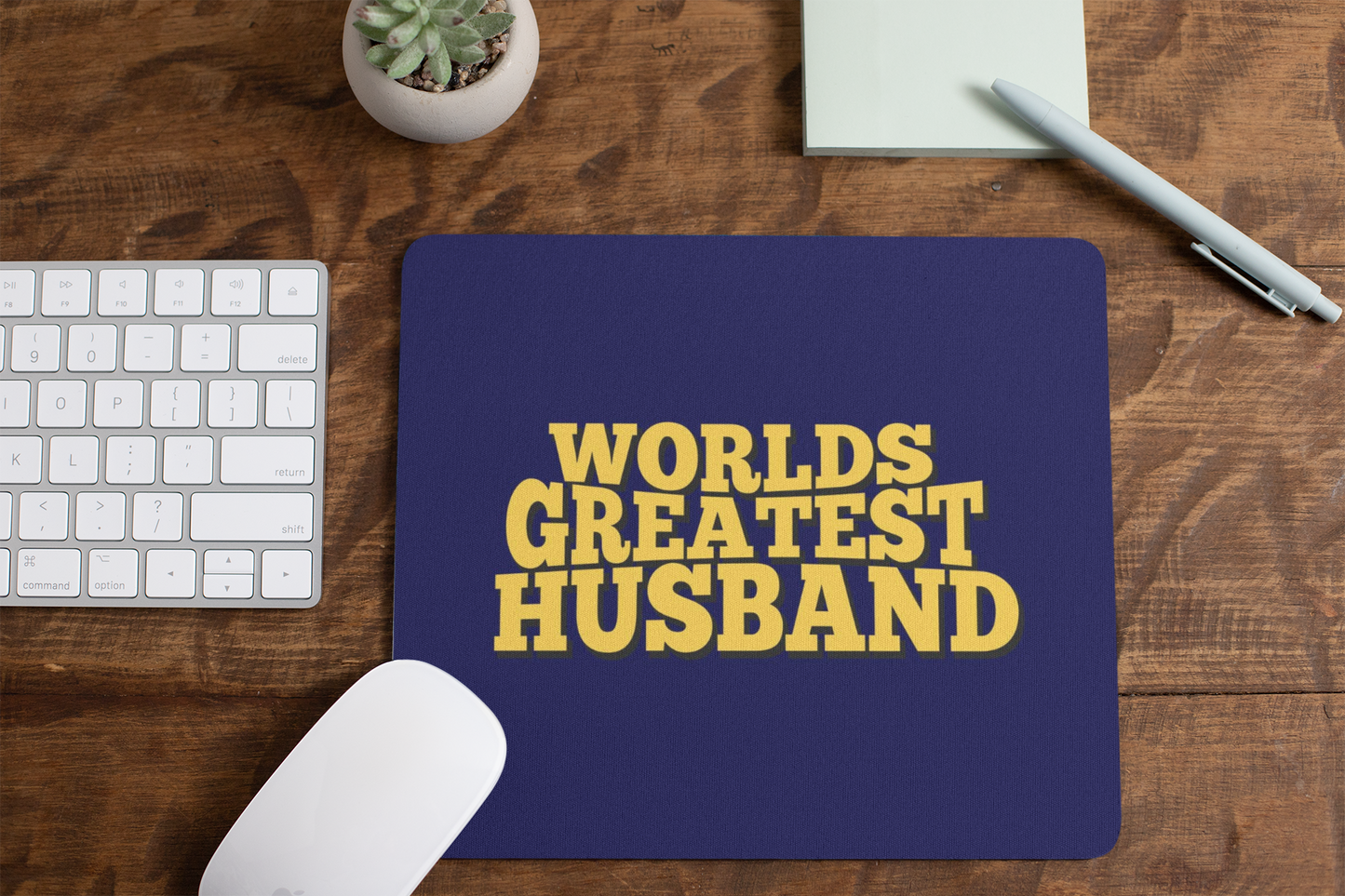 mousepad-mockup-lying-on-a-table-next-to-a-plant-pot-and-some-office-supplies-27553