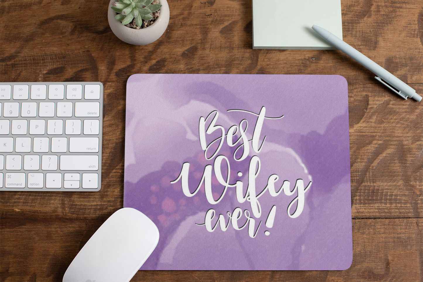 mousepad-mockup-lying-on-a-table-next-to-a-plant-pot-and-some-office-supplies-27553