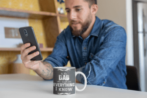 mug-mockup-featuring-a-tattooed-man-checking-his-messages-24025-1-1