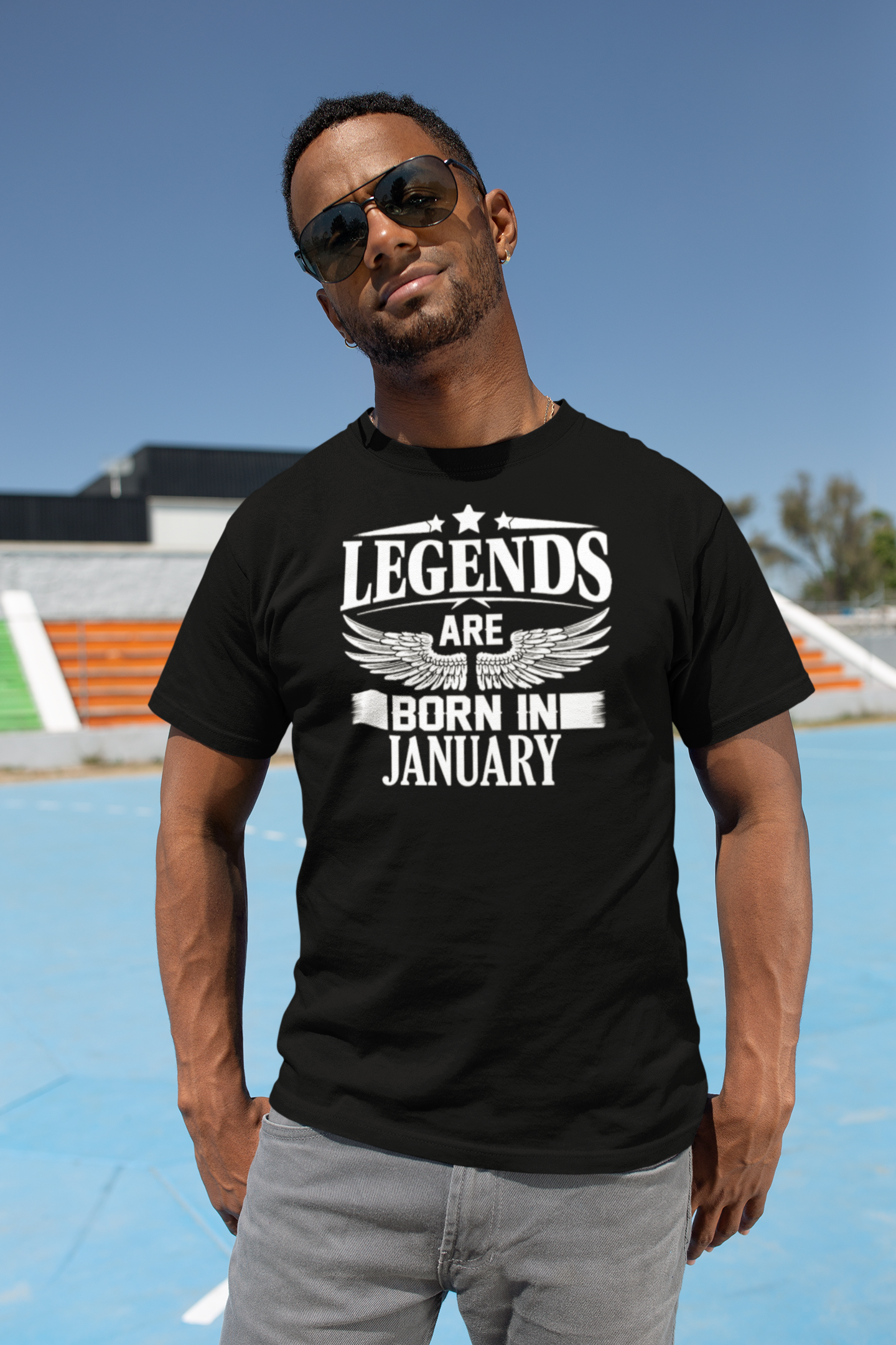 t-shirt-mockup-of-a-muscled-man-wearing-sunglasses-in-a-sports-field-25933