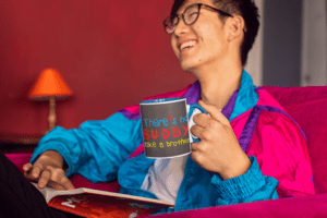 11-oz-colored-rim-mug-mockup-featuring-a-joyful-man-reading-on-a-couch-27823-2-1