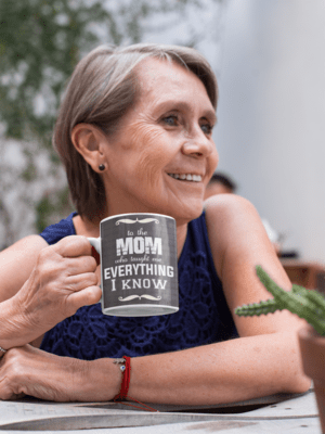 11-oz-mug-mockup-featuring-a-smiling-elderly-woman-at-a-table-27434-1