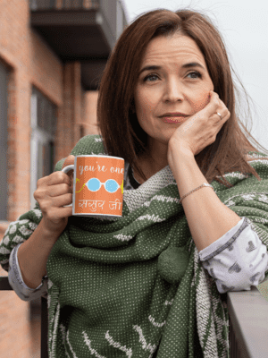 mockup-of-a-middle-aged-woman-holding-an-11-oz-coffee-mug-outside-31600-1