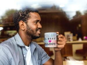 young-man-at-a-coffee-shop-holding-his-mug-mockup-a12325-1